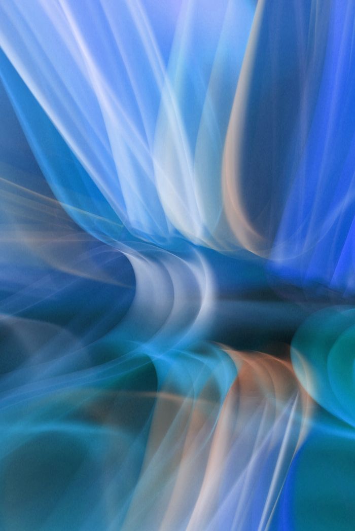 heros-img Dynamic abstract image of swirling blue and orange light streaks creating a sense of movement and flow.